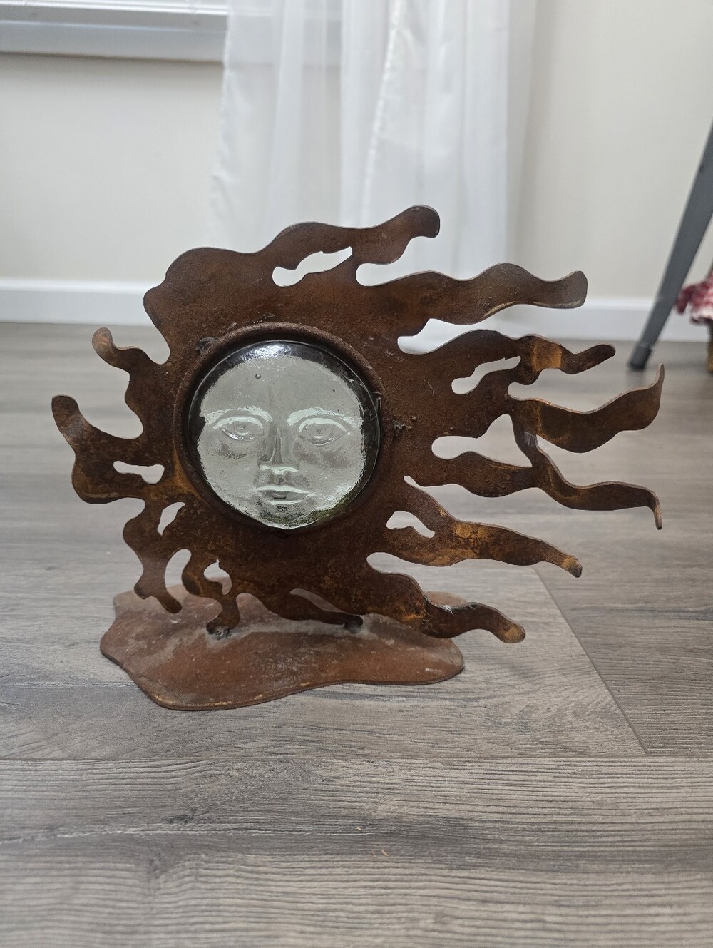 Rustic metal and molded glass celestial sun face candle holder